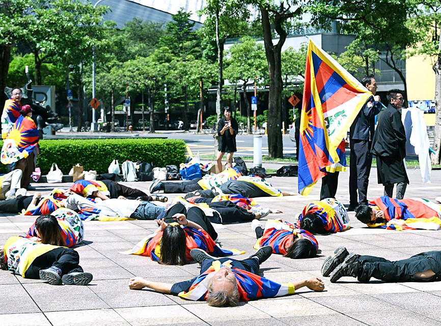 Tibetan activists protest China ethnic unity law at bank